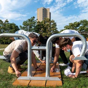 Students assembling a picnic table